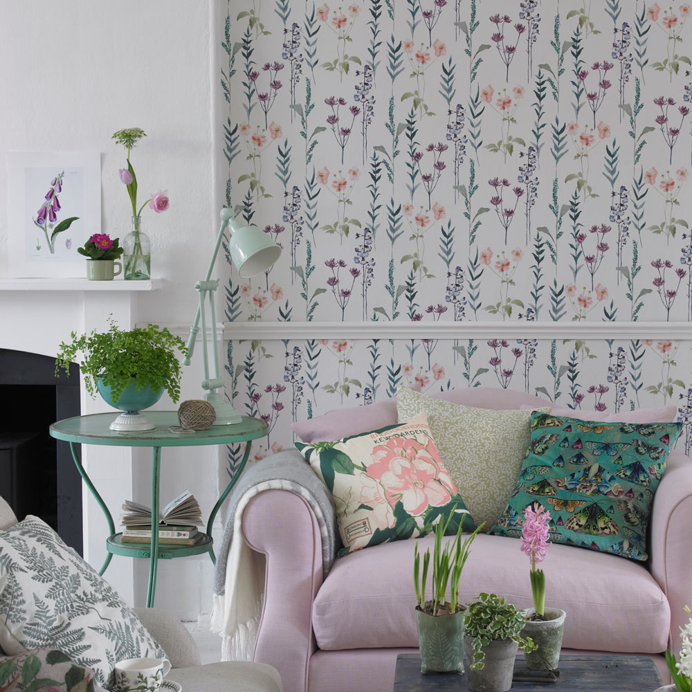 small living room with snuggler and floral print wallpaper