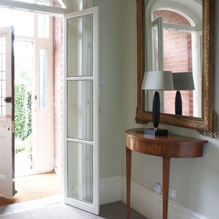house entrance hallway with white wall and mirror