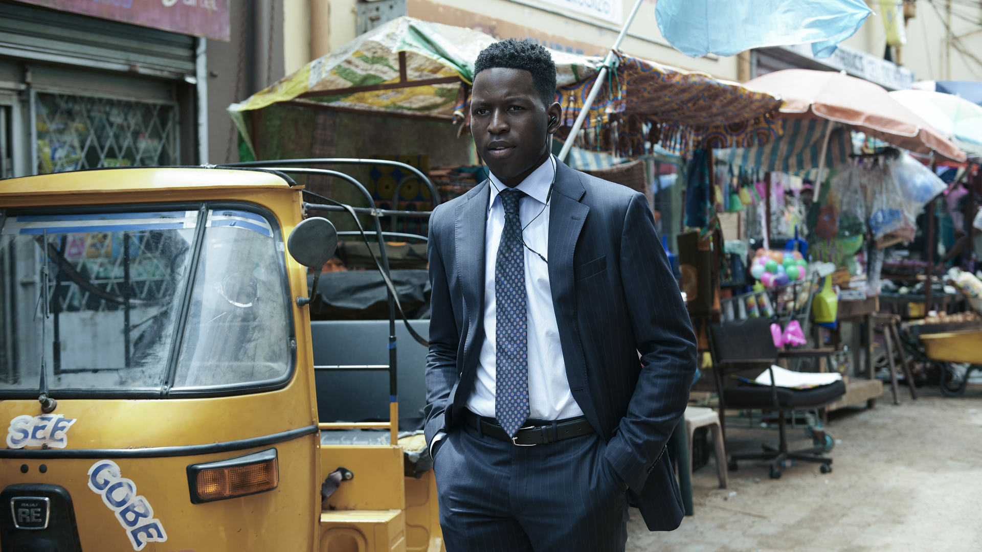 Tunde Ojo walks down a street with his hands in his pockets in Prime Video's The Power