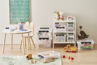 Childrens play and l;earning area with small table, blackboard and clear storage boxes for toys
