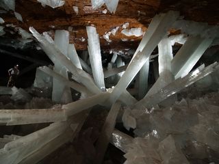 A man (left) explores the Giant Crystal Cave of Naica in Mexico.