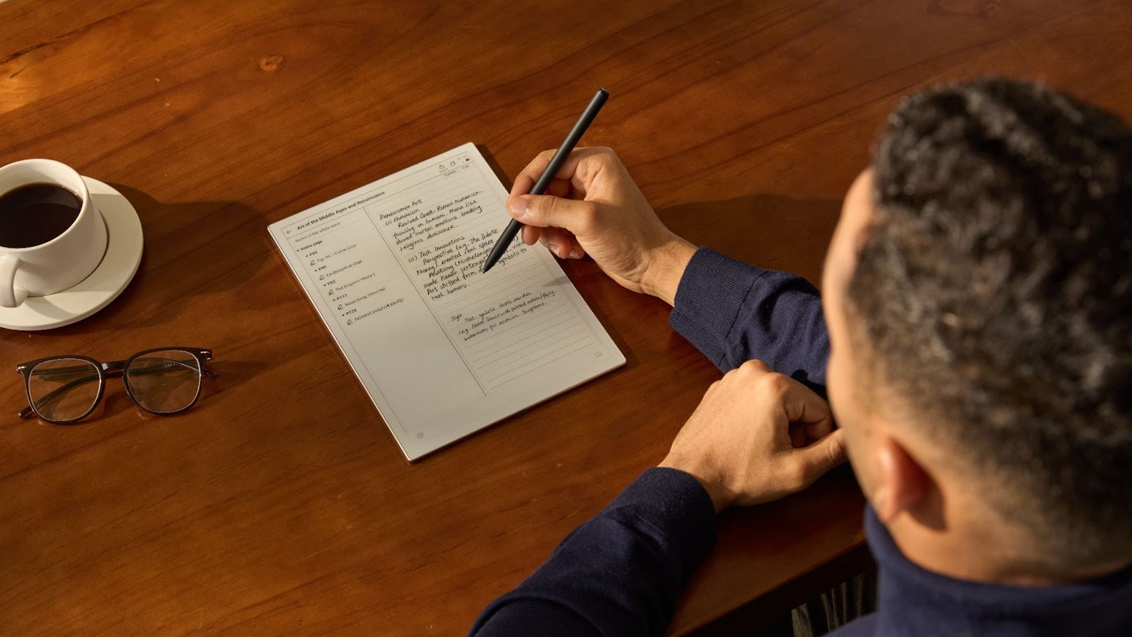 A male figure using the iFLYTEK AINOTE 2 paper tablet