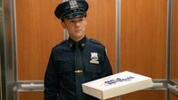Harrison shows up to work with donuts for his coworkers on the police force. He's dressed in a blue cop uniform. 