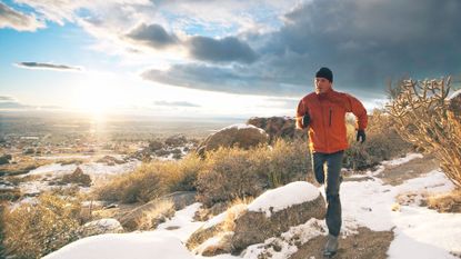 Man trail running in winter