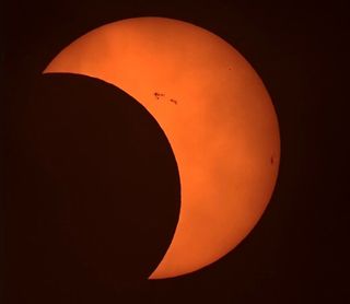 eclispe views show the moon taking a large bite out of the sun, the sun appears as a large crescent. 