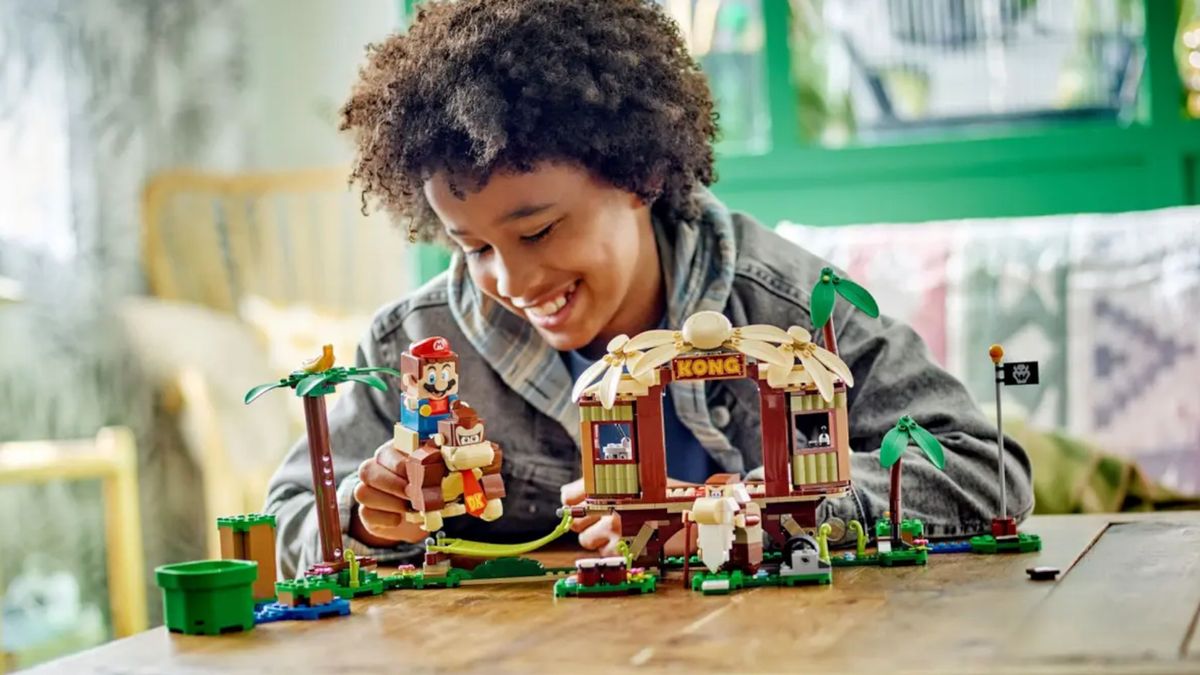 Lego Donkey Kong's Tree House being played with by a child at a table