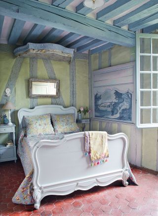 Blue French bedroom with painted beams and french bed with coronet