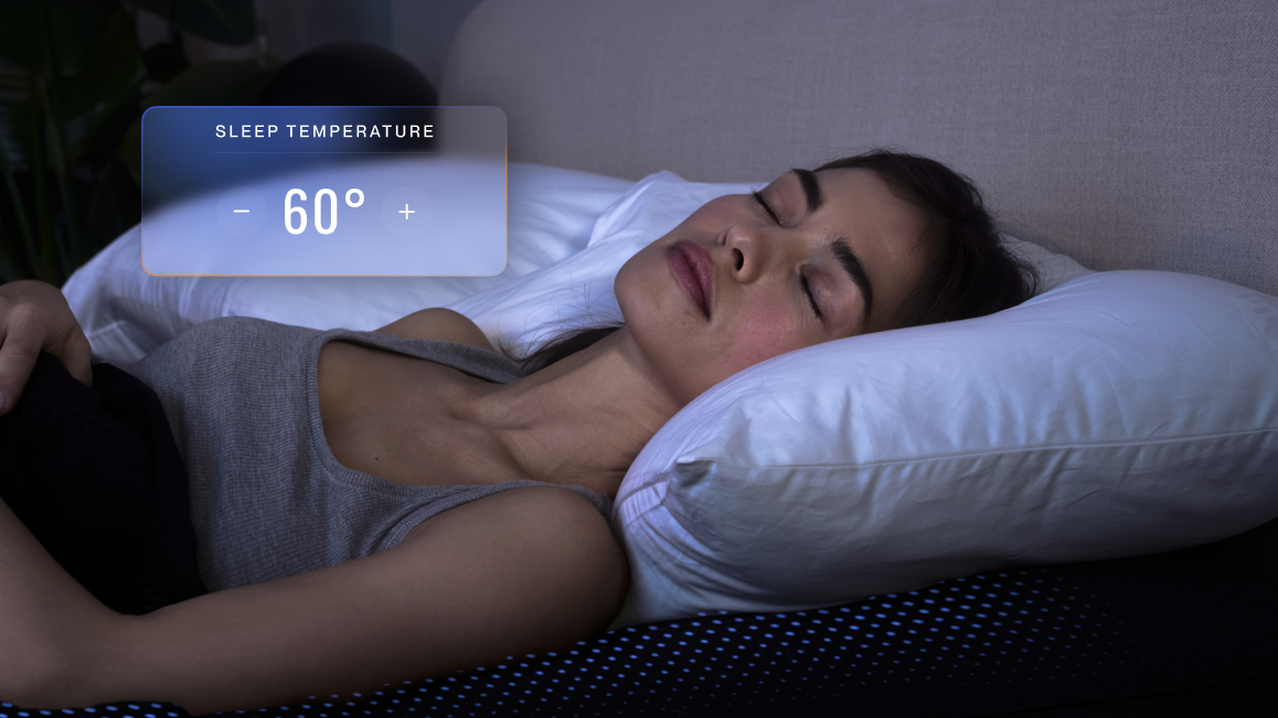 A woman sleeping on a bed using The Pod by Eight Sleep