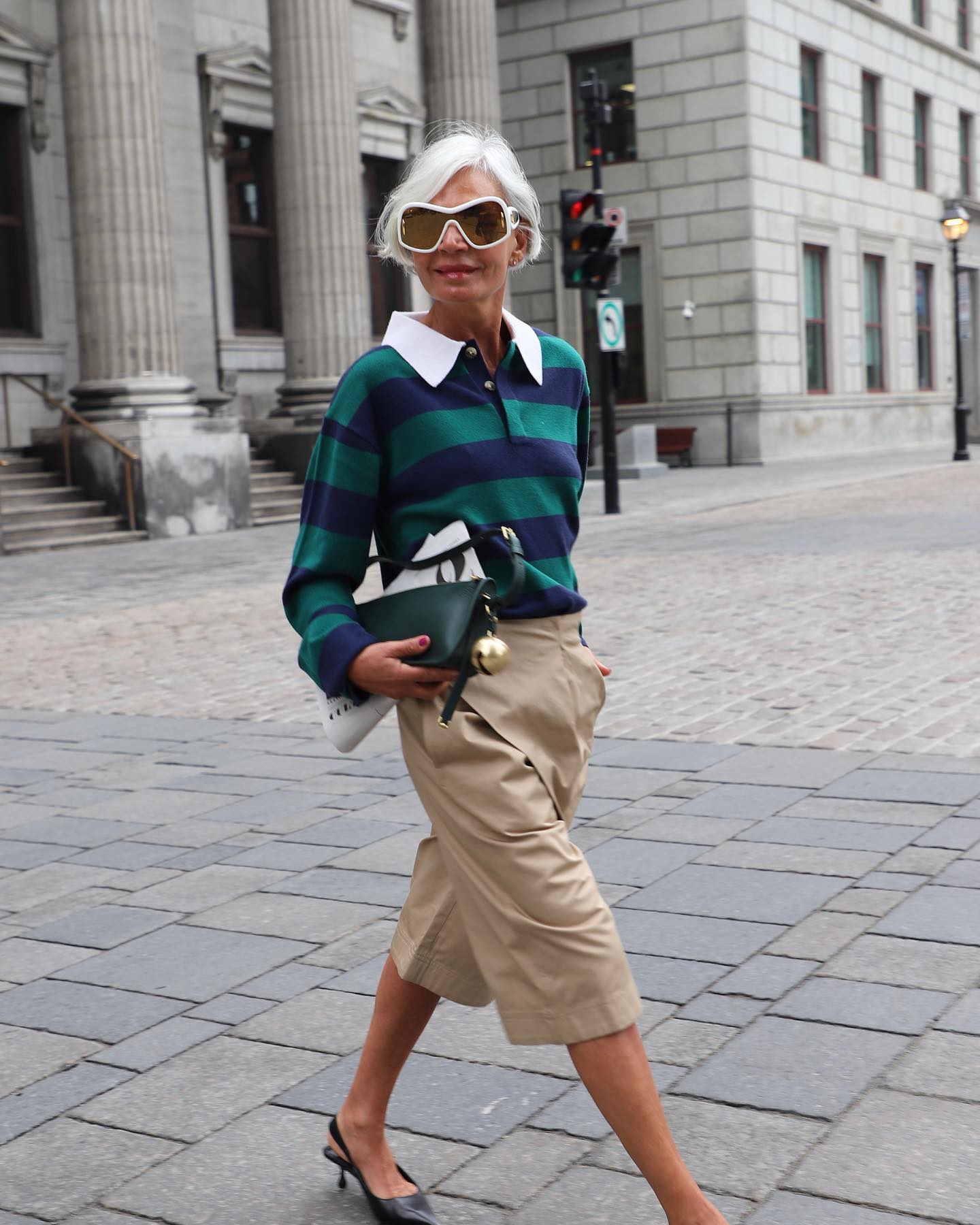 A woman wearing long shorts with a polo