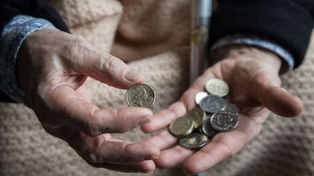 Coins being counted by dirty hands