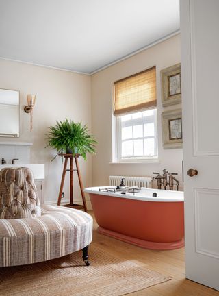 bathroom with orange tub and seating