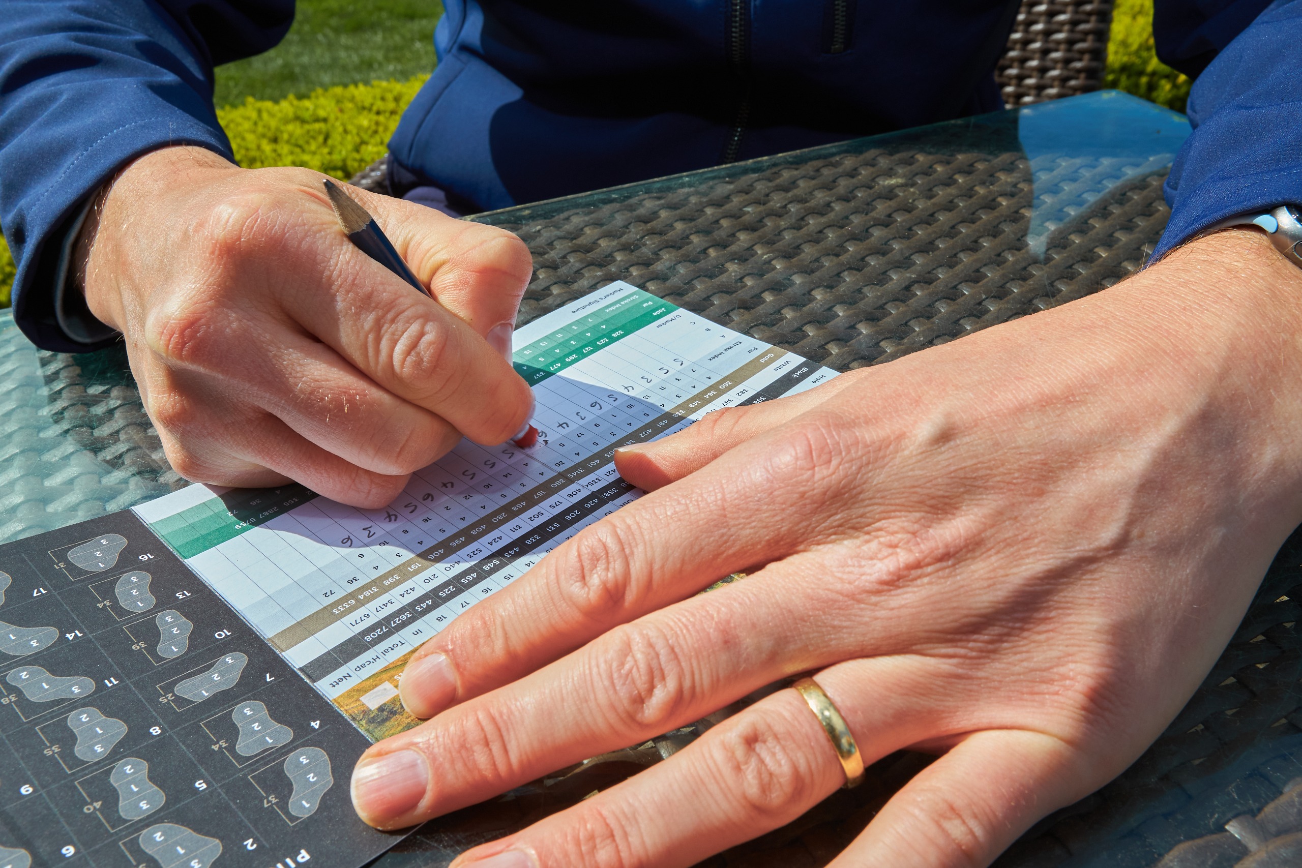 a golfer erasing a score on a scorecard to indicate cheating