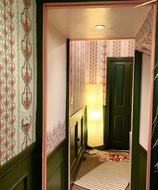 Pink and green hallway design with green paint and pink printed wallpaper by Lick Home