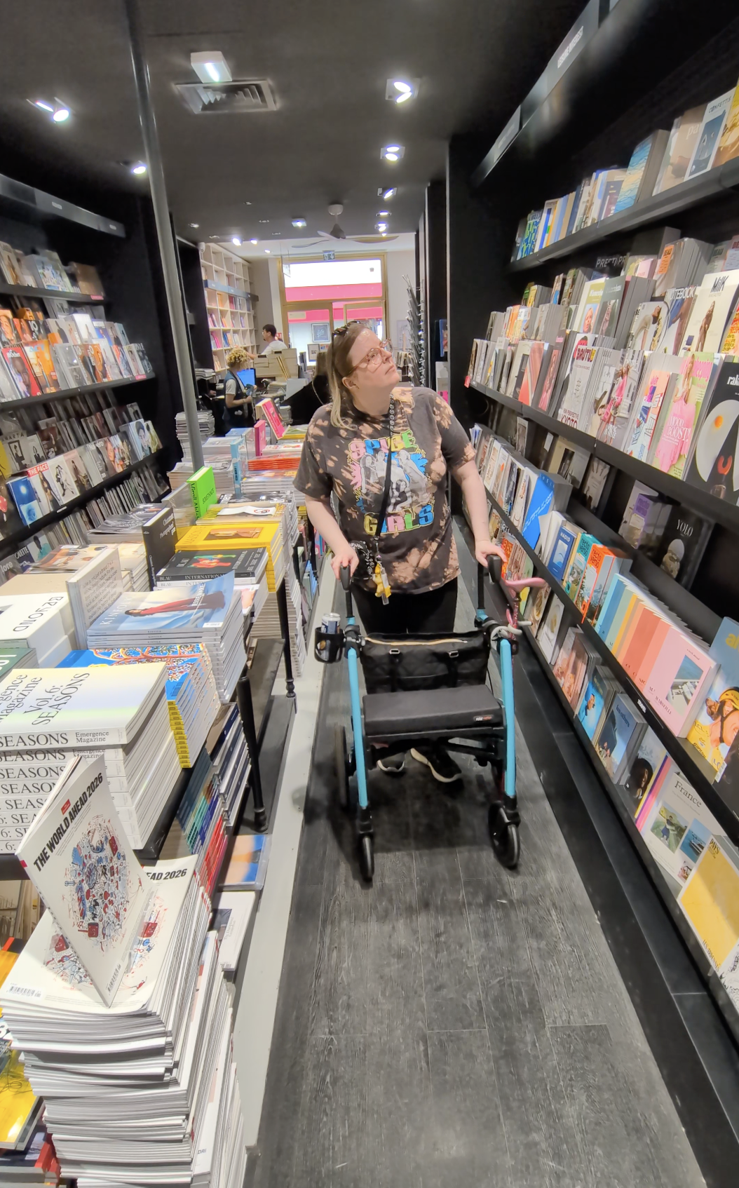 Using a Rollz Motion Rollator in a French bookstore, browsing magazines