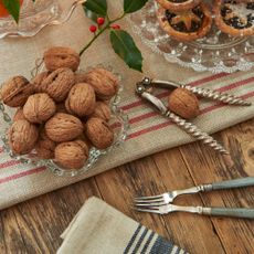 Walnuts with a nutcracker on a vintage table
