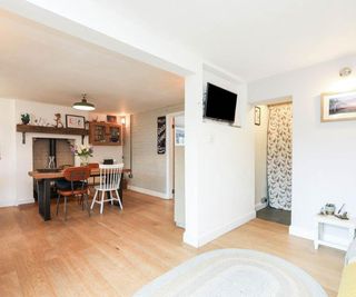 open plan dining room with stud wall with wall mounted tv