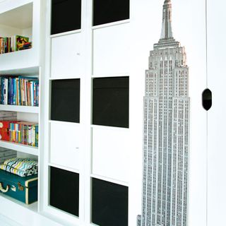room with books on white storage wall