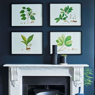 marble fireplace with mantlepiece with four wall artworks displayed above