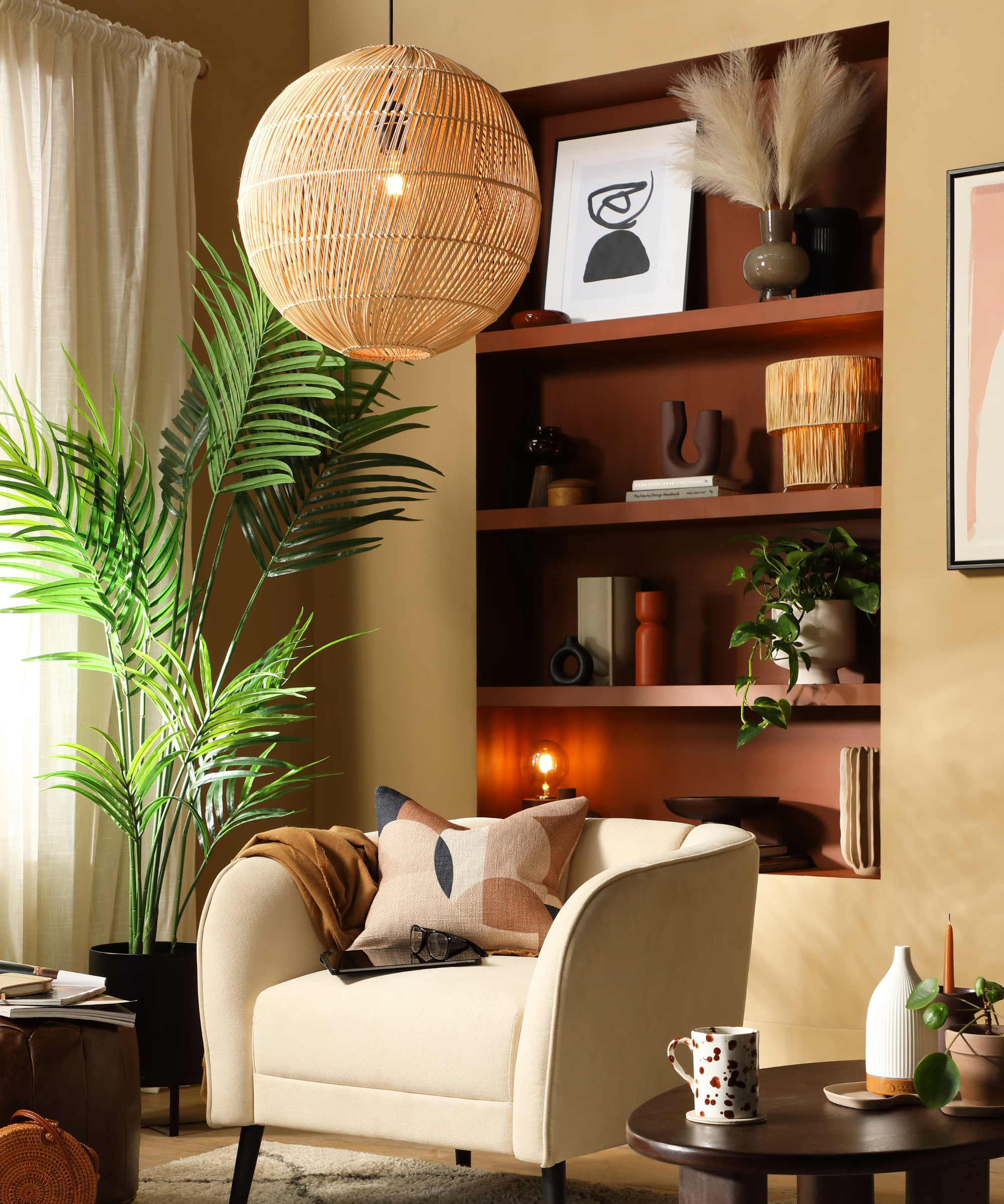 Living room with shelved alcove painted in dark brown against light olive walls behind an arm chair