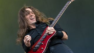 A photograph of Megadeth guitarist Kiko Loureiro on stage