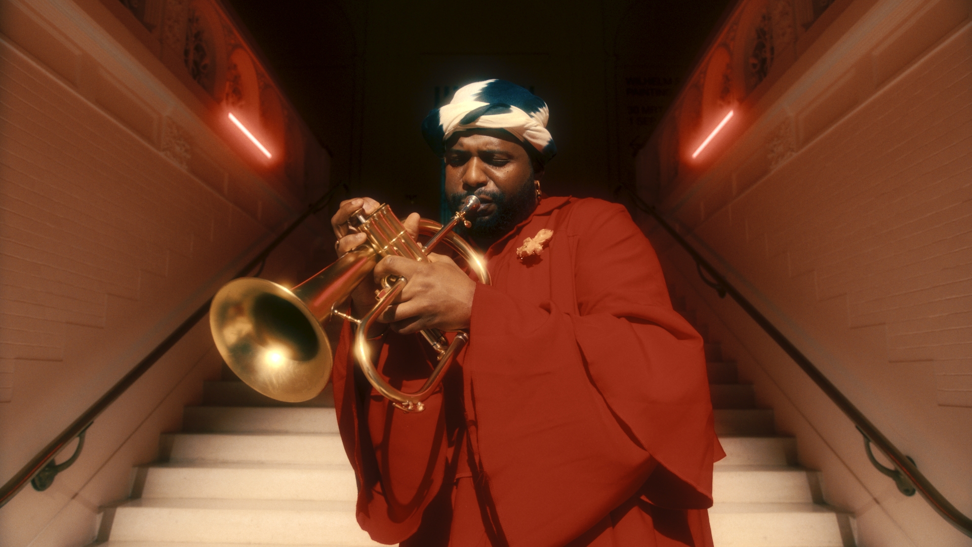 man playing saxophone on the stairs