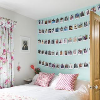 bedroom with blue wall and photos on wall