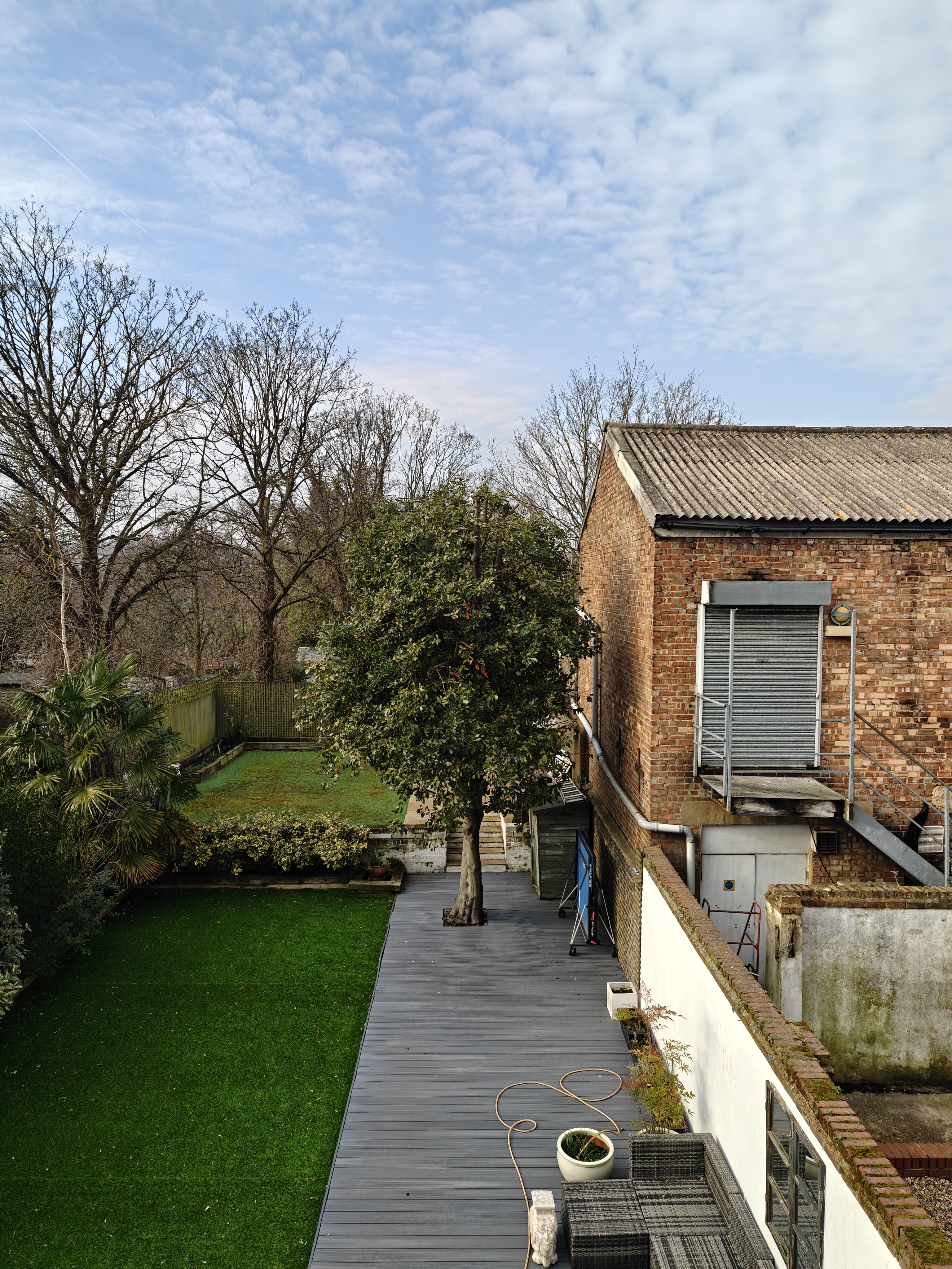 A garden next to a brick warehouse