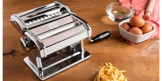 pasta machine with egg and bowl