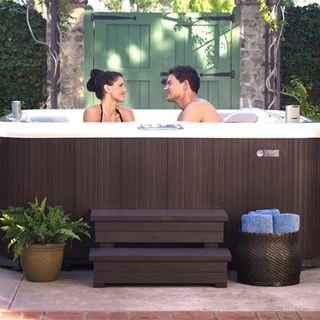 outdoor jacuzzi with two people in it