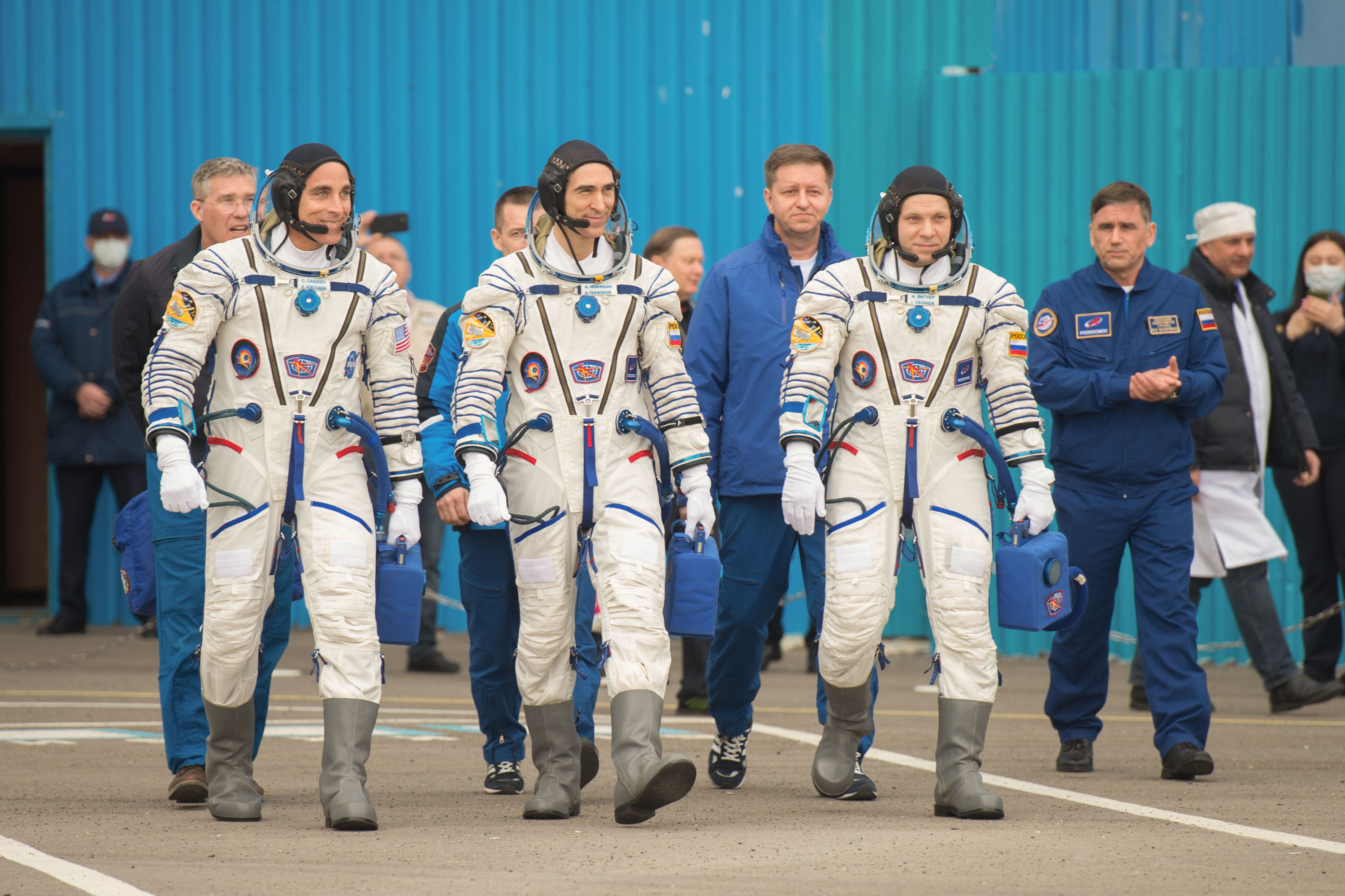 NASA astronaut Chris Cassidy (left) and Russian cosmonauts Anatoly Ivanishin (center) and Ivan Vagner depart building 254 and head to the launch pad at the Baikonur Cosmodrome in Kazakhstan, on April 9, 2020.