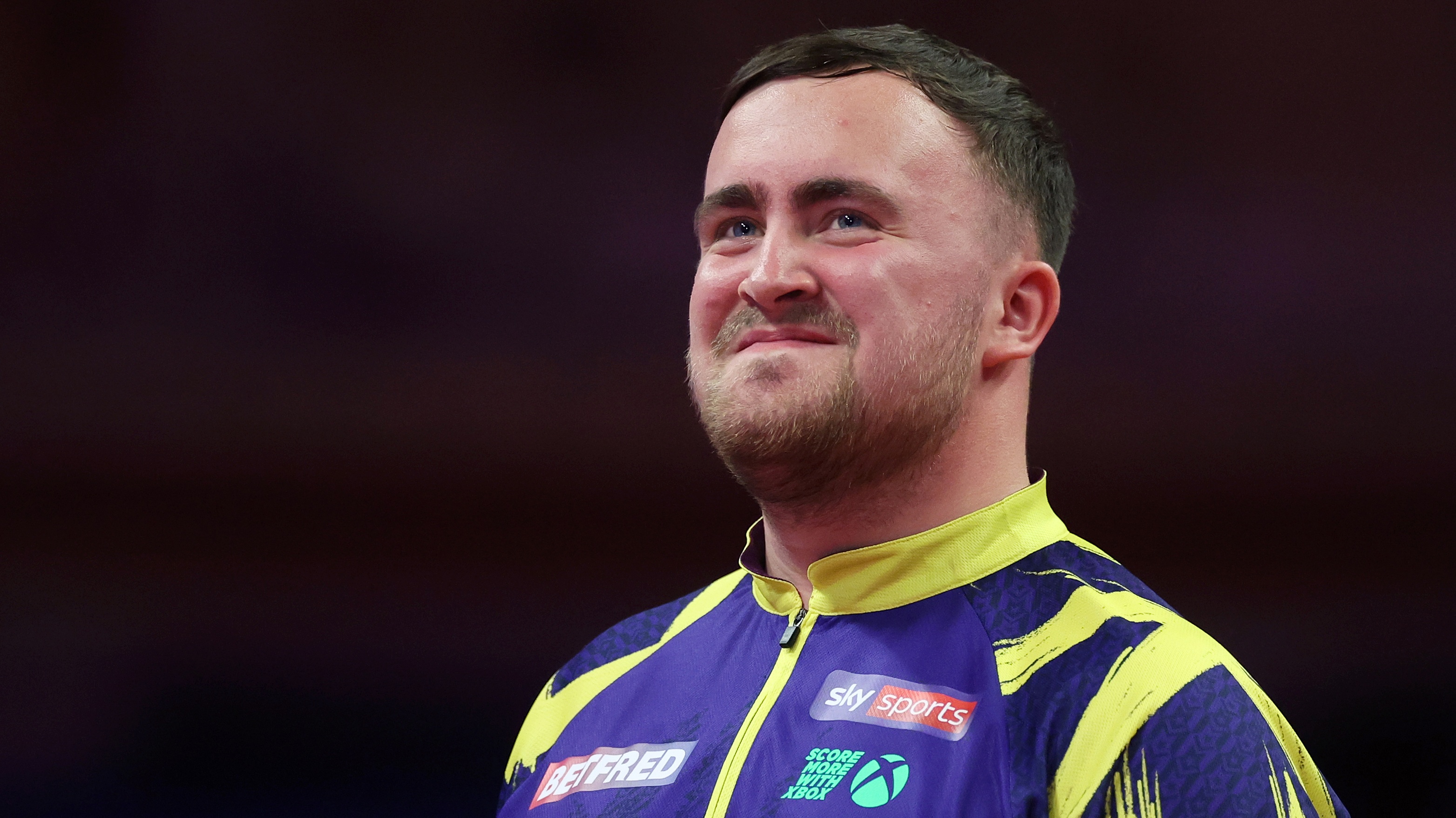 Luke Littler of England smiles during the Final match between James Wade of England and Luke Littler of England on day nine of the 2025 Betfred World Matchplay at Winter Gardens on July 27, 2025 in Blackpool, England. 