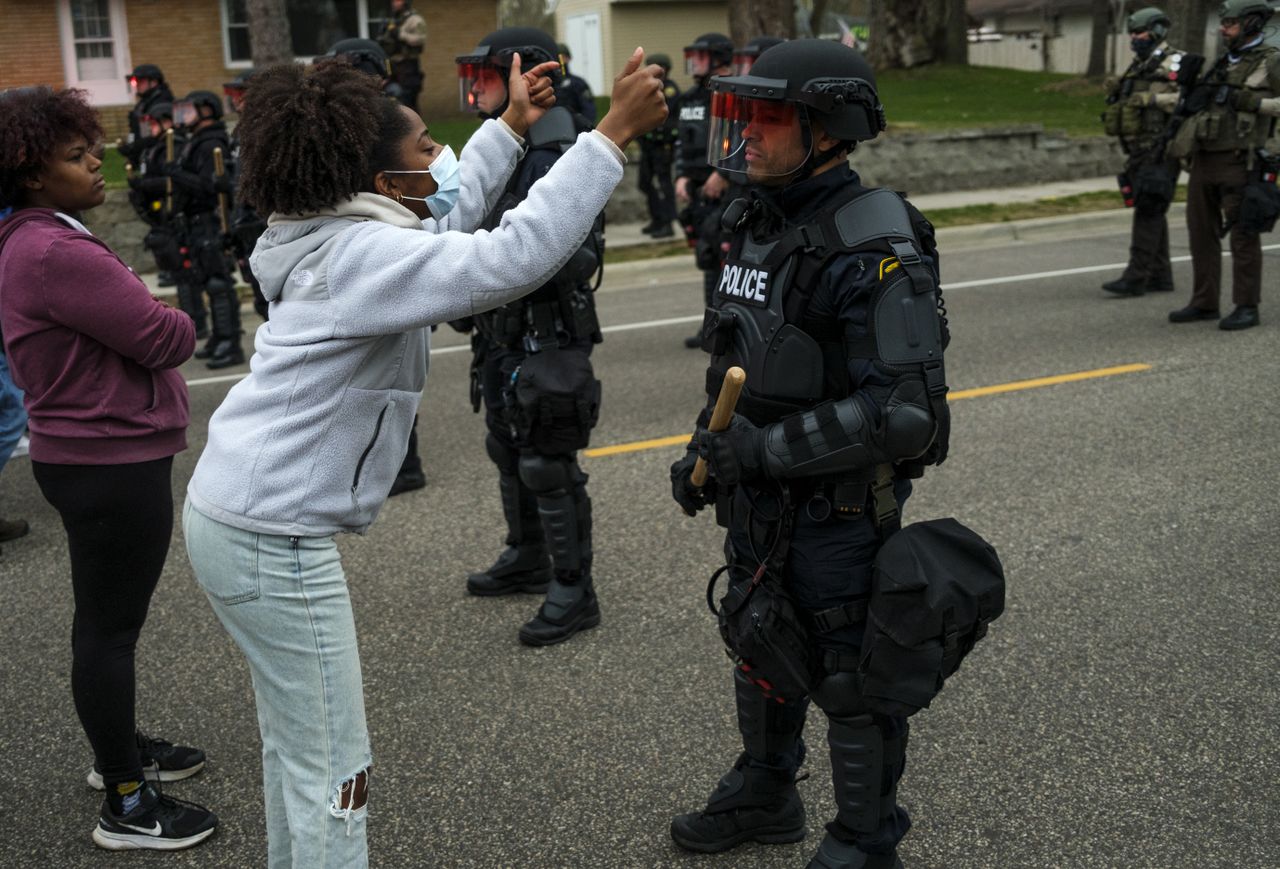 A protester and a police officer in Brooklyn Center