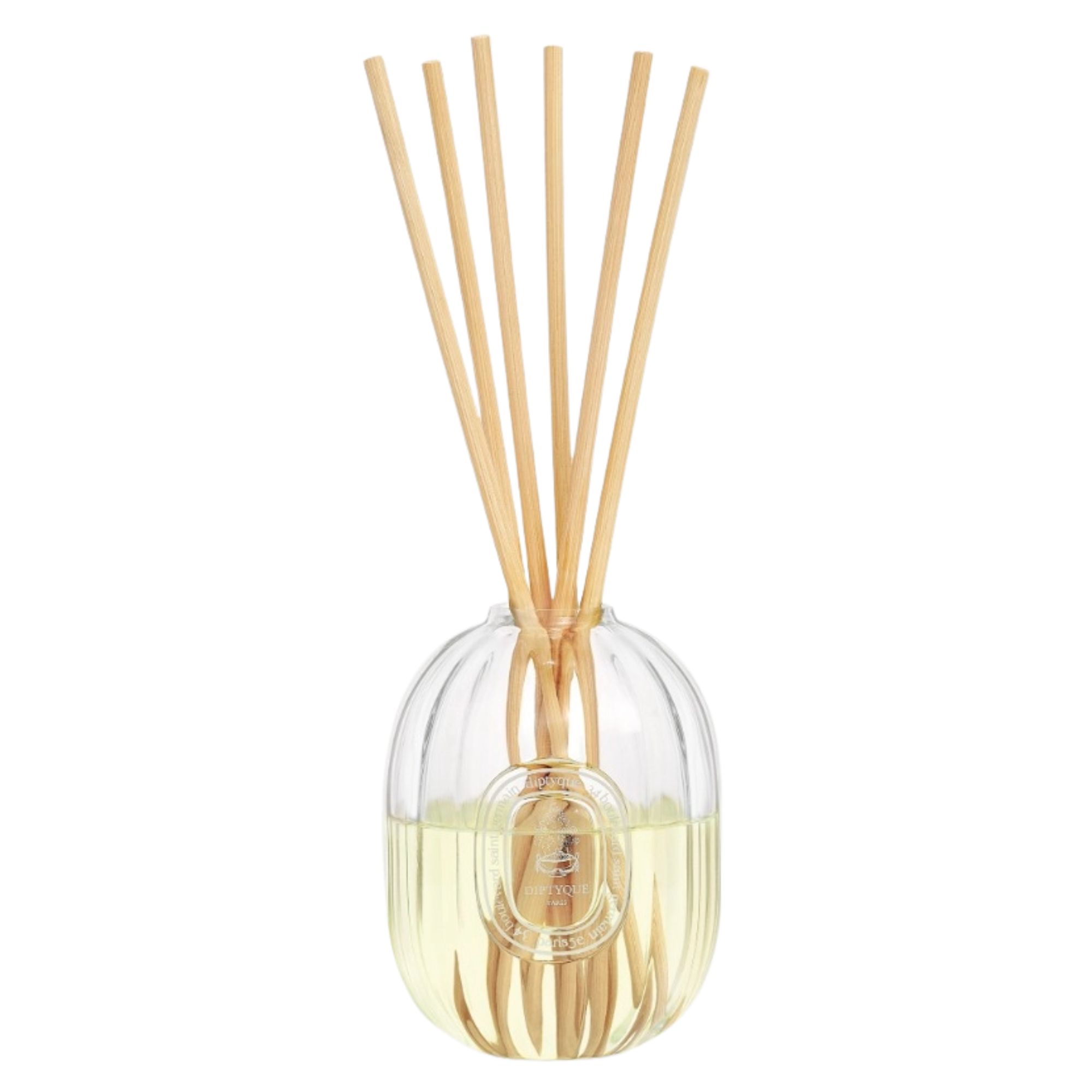 Diptyque Ambre diffuser with a fluted glass vessel and wooden reeds