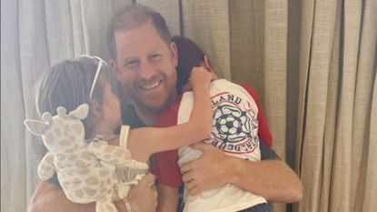 A screenshot of Meghan Markle's Instagram post for Father's Day, featuring Prince Harry hugging Archie and Lilibet