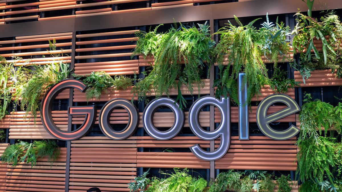 A photo of the Google Logo surrounded by plants at the company&#039;s NYC headquarters building