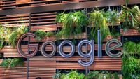 A photo of the Google Logo surrounded by plants at the company's NYC headquarters building