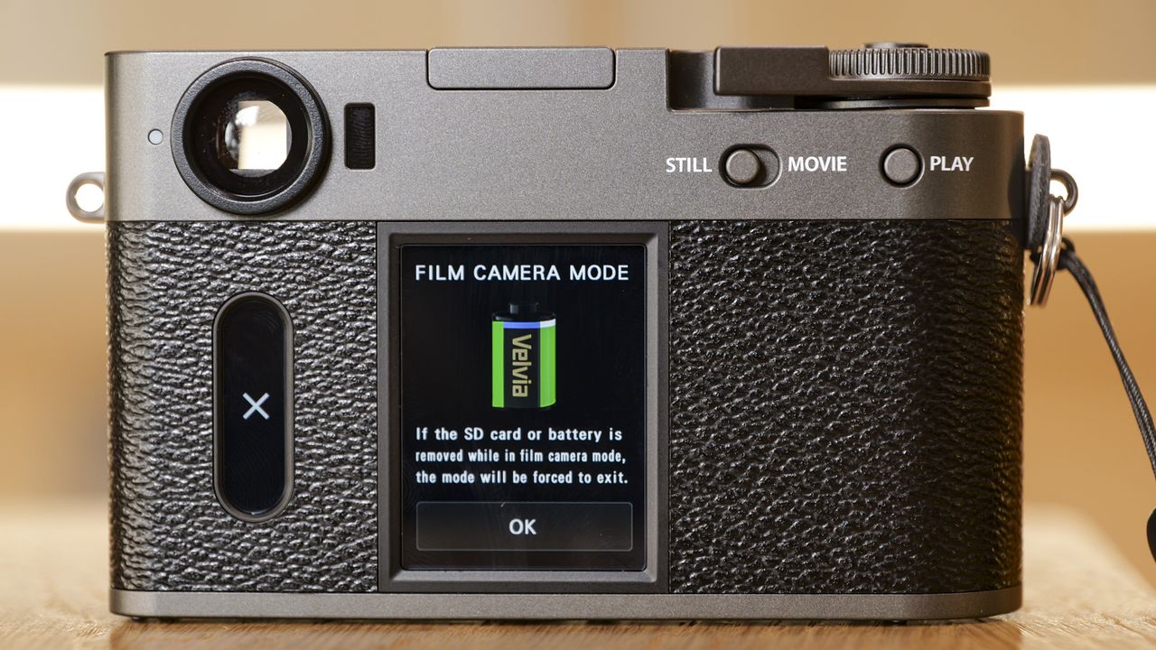 Fujifilm X half compact camera's back, on a wooden surface