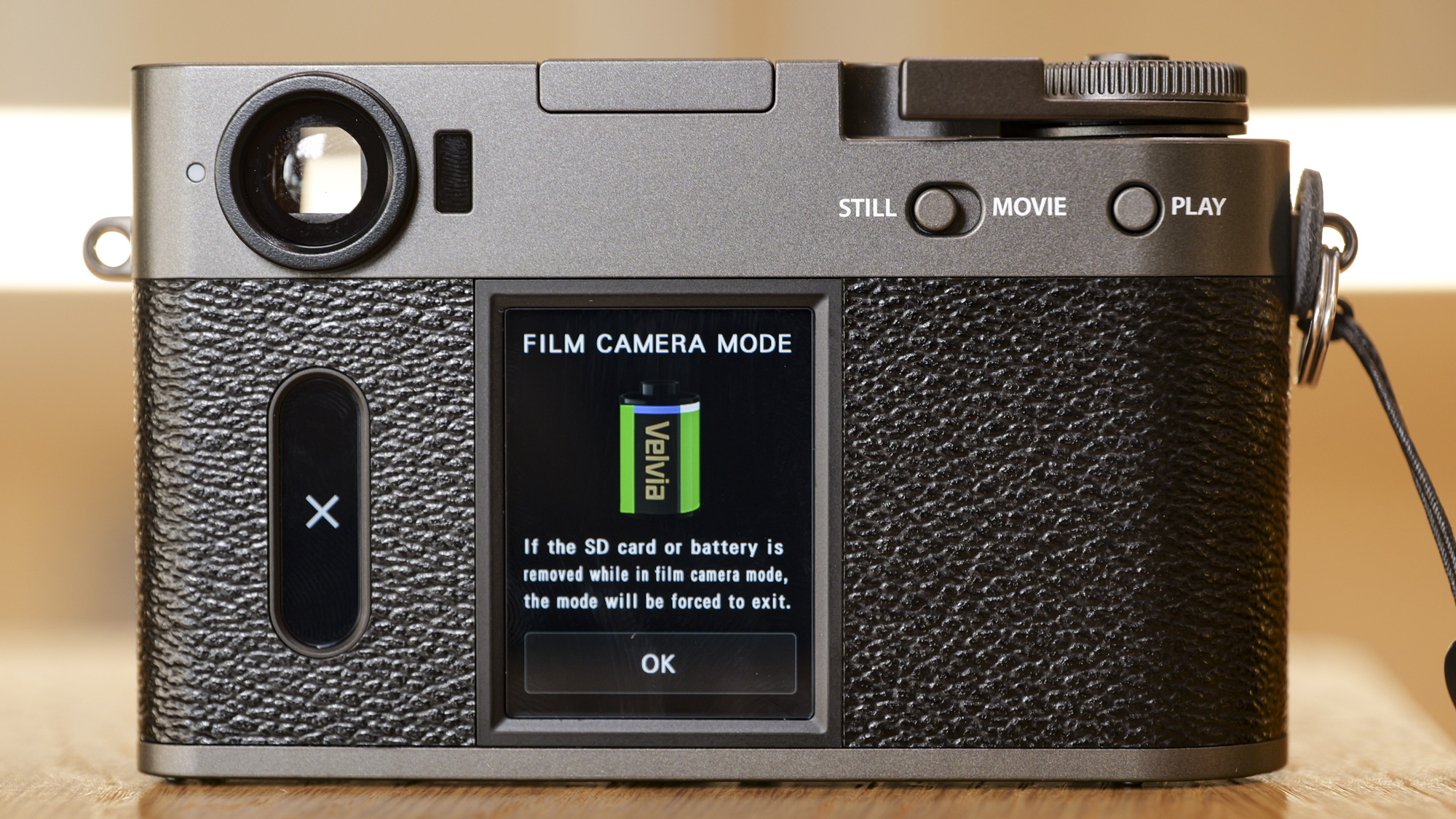 Fujifilm X half compact camera's back, on a wooden surface