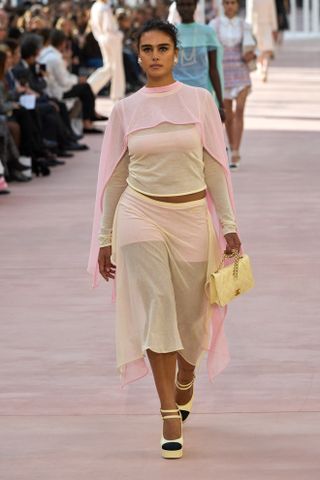 Woman wearing pale pink and yellow on the runway