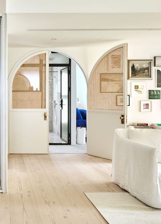 an apartment with rattan doors dividing rooms