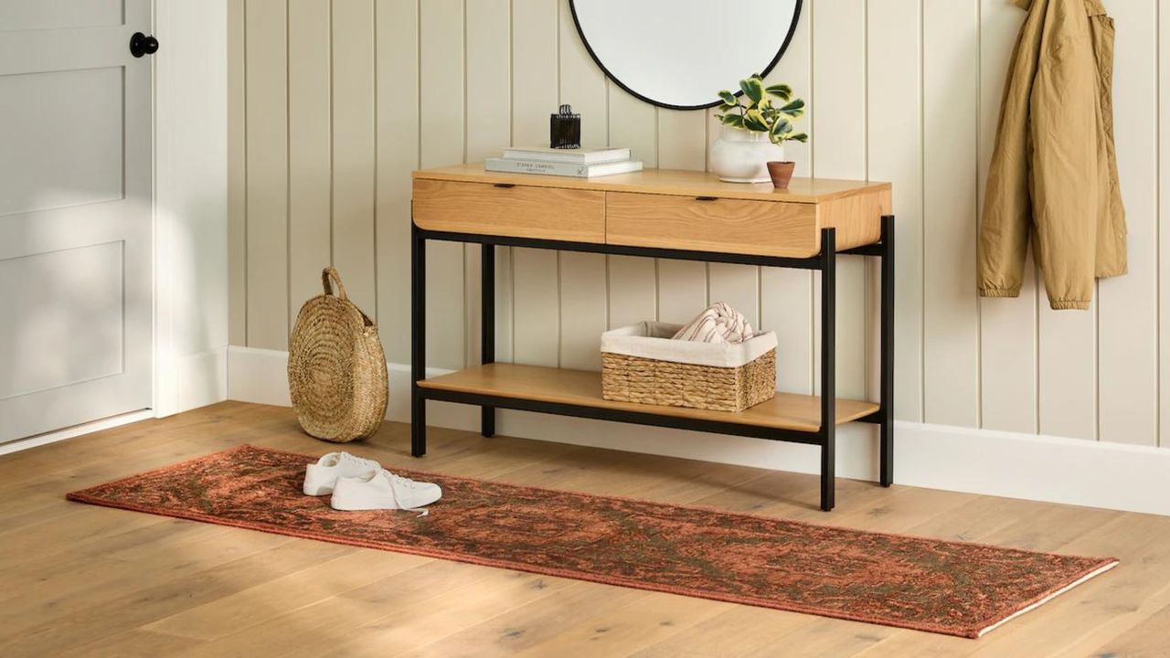 Entryway with red rug and console table