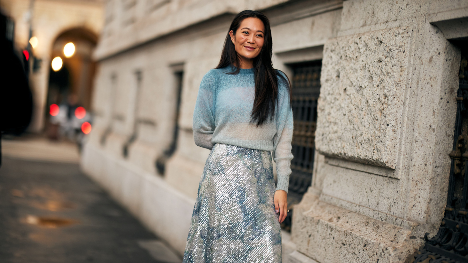 woman wearing a lightweight sweater and a sparkly skirt