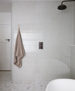 a curved bathroom wall with tiles