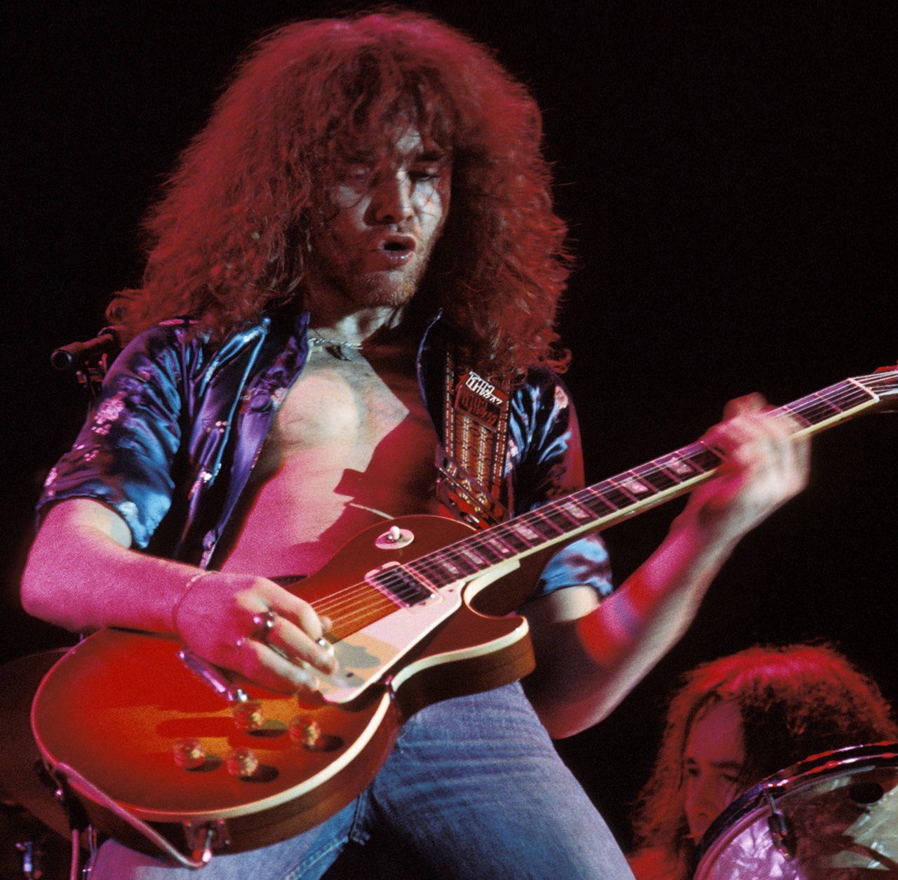 Brian Robertson wields a Gibson Les Paul Deluxe guitar onstage with Thin Lizzy at the Great British Music Festival