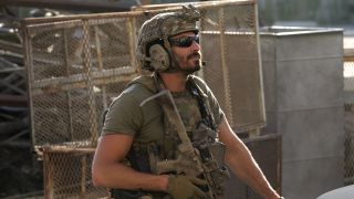 Brock Reynolds in full gear holding gun in SEAL Team