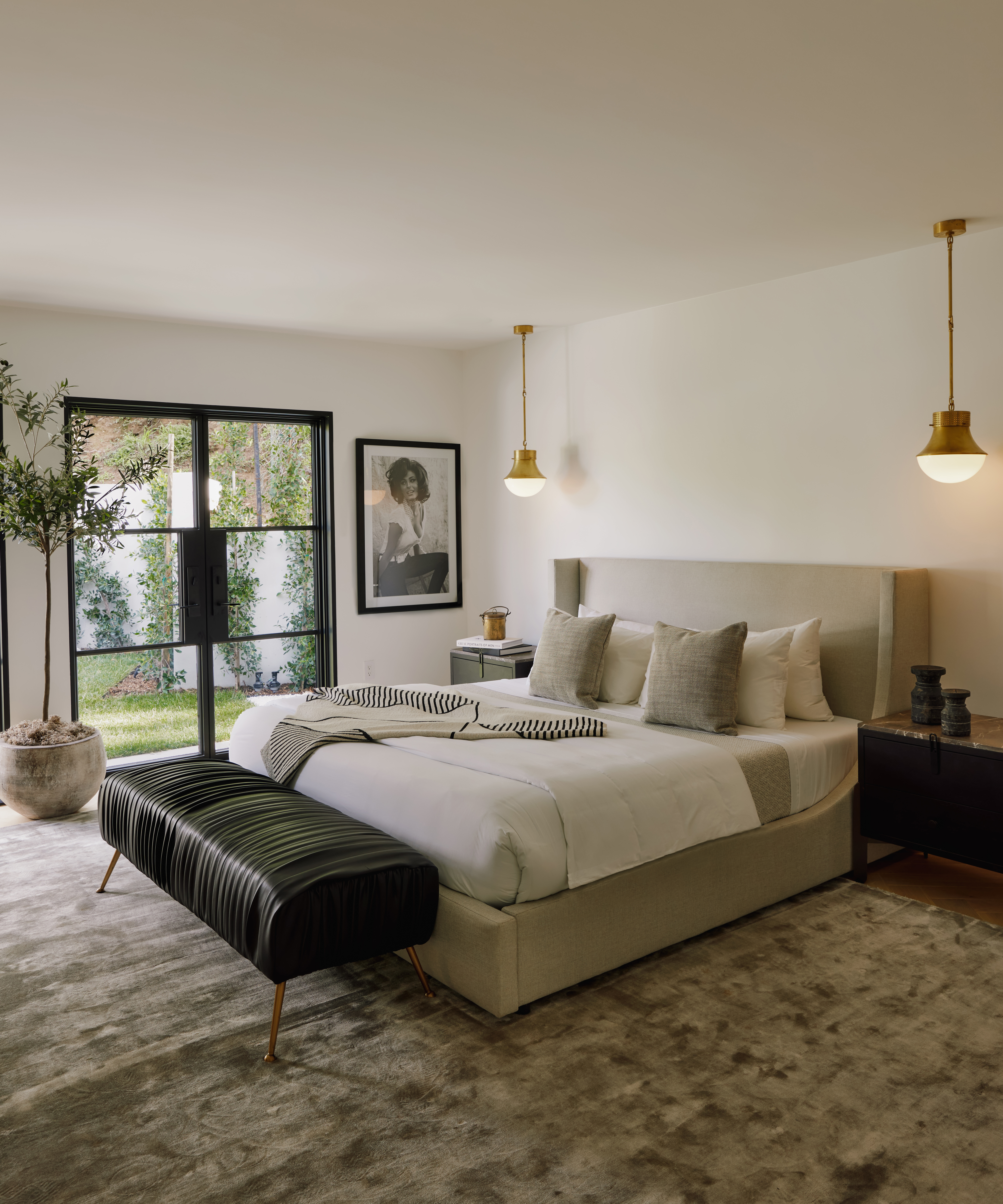 gray bedroom with gray pillows and gold ceiling lights