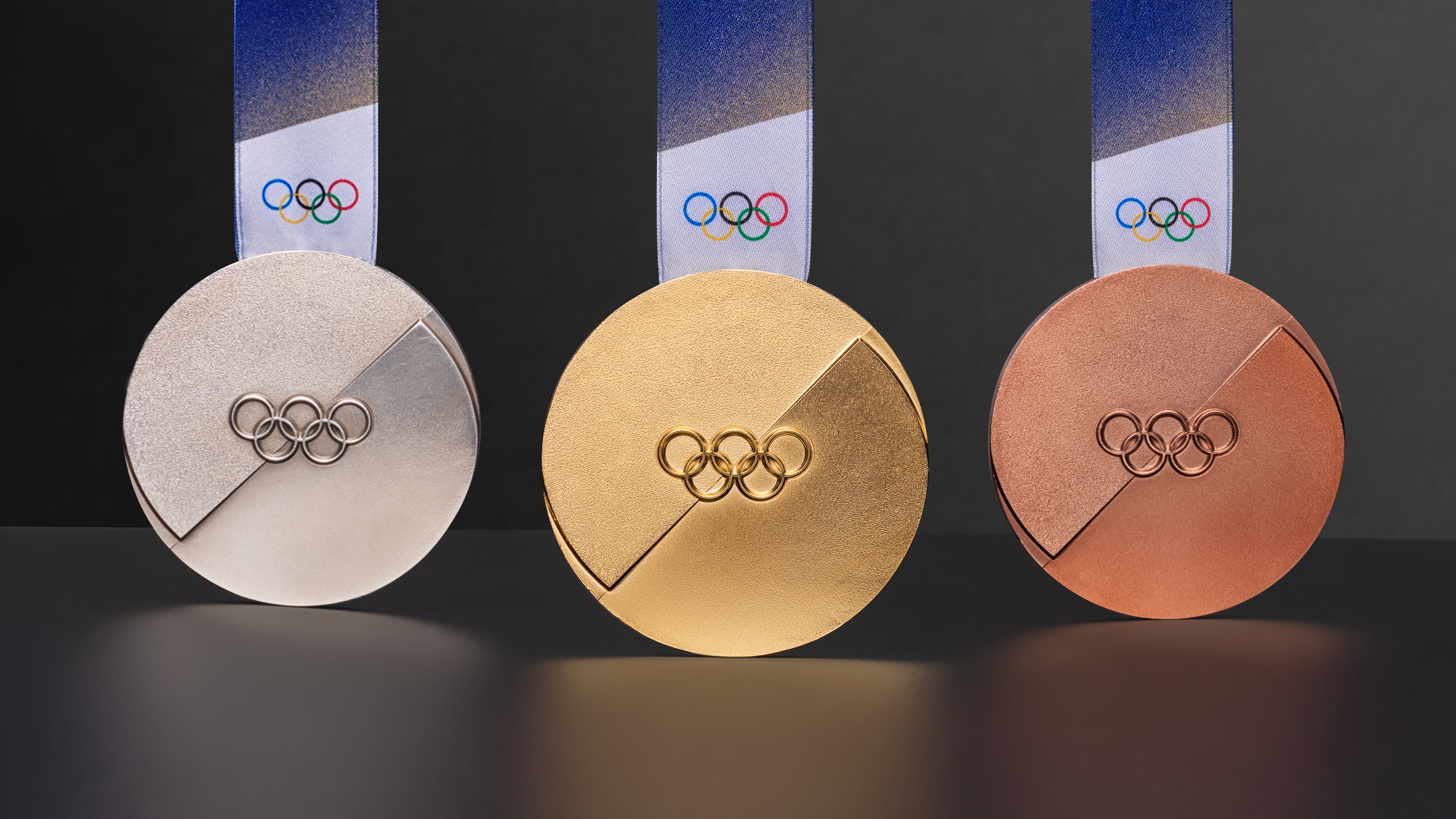 Medals for Winter Olympics 2026: gold, silver and bronze, with blue ribbon