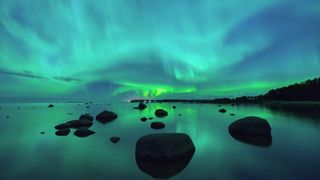 The northern aurora lights up the sky over the Gulf of Finland.