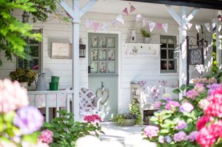 veranda porch with painted vintage furniture bunting and gingham and patchwork quilts