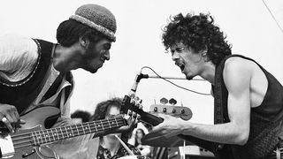 Carlos Santana and bassist David Brown performing at the Woodstock festival in 1969